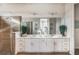 An elegant bathroom features a double vanity and a glass-enclosed shower with stone floors at 3881 Sonoma Blvd, Kissimmee, FL 34741