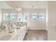 Bright bathroom boasts a double vanity with plentiful light, and attractive flooring at 3881 Sonoma Blvd, Kissimmee, FL 34741