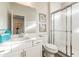 Bright bathroom features a walk-in shower with glass doors and a modern white vanity with a large mirror at 3881 Sonoma Blvd, Kissimmee, FL 34741