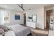 Bright bedroom featuring wood floors, stylish decor, ceiling fan, and ensuite bathroom at 3881 Sonoma Blvd, Kissimmee, FL 34741