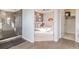 Open view of bedroom with a gray accent wall, with direct access to a glass-walled shower at 3881 Sonoma Blvd, Kissimmee, FL 34741