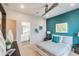 Stylish bedroom with modern decor, an accent wall, and plush carpeting. Adjacent bathroom at 3881 Sonoma Blvd, Kissimmee, FL 34741