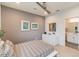 Tastefully decorated bedroom with a gray accent wall, artwork, and a sleek white dresser at 3881 Sonoma Blvd, Kissimmee, FL 34741