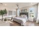 Bright bedroom with a king bed, two windows and an elegant headboard at 3881 Sonoma Blvd, Kissimmee, FL 34741