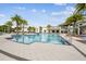 Resort style community pool surrounded by lounge chairs and swaying palm trees at 3881 Sonoma Blvd, Kissimmee, FL 34741