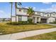 Modern two-story home featuring a landscaped front yard, two-car garage, and light colored stucco at 3881 Sonoma Blvd, Kissimmee, FL 34741