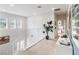 Bright upstairs hallway with a modern railing, stylish decor, and views of the outdoors at 3881 Sonoma Blvd, Kissimmee, FL 34741