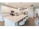 Modern kitchen with white cabinets, stainless steel appliances, and a large center island with seating at 3881 Sonoma Blvd, Kissimmee, FL 34741