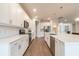 Bright modern kitchen features white cabinetry, quartz countertops, and state-of-the-art appliances at 3881 Sonoma Blvd, Kissimmee, FL 34741