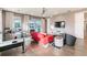 Comfortable living room featuring a red sofa, game table, and sliding glass doors to the outdoor patio at 3881 Sonoma Blvd, Kissimmee, FL 34741