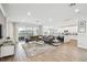 Bright, open-concept living area with sleek tile flooring, modern furniture, and access to outdoor space at 3881 Sonoma Blvd, Kissimmee, FL 34741
