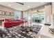 Inviting living room with a comfortable sofa, stylish decor, and views of the outdoor patio and pool at 3881 Sonoma Blvd, Kissimmee, FL 34741