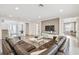 Open-concept living room features modern decor, wood floors, and plenty of natural light at 3881 Sonoma Blvd, Kissimmee, FL 34741