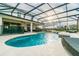 Outdoor pool area with a sunny pool deck and screened enclosure at 3881 Sonoma Blvd, Kissimmee, FL 34741