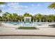 Community pool with palm trees, lounge chairs, and decorative waterfall feature at 3881 Sonoma Blvd, Kissimmee, FL 34741