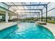 Outdoor pool area with sun loungers and a screened enclosure at 3881 Sonoma Blvd, Kissimmee, FL 34741