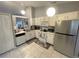 Bright kitchen offering white appliances, cabinets, and a practical tile floor at 1018 Martin Blvd, Orlando, FL 32825
