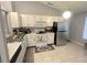 Functional kitchen featuring white cabinets, modern appliances, and easy-to-clean tile flooring at 1018 Martin Blvd, Orlando, FL 32825