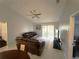 Comfortable living room with tile floors, ceiling fan, sliding glass doors to a patio, and leather sofas at 1018 Martin Blvd, Orlando, FL 32825