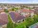 An aerial view shows the home's backyard, patio, and landscaping within a community at 10257 Henbury St, Orlando, FL 32832