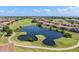 Aerial view of community golf course with a tranquil lake, lush fairways, and manicured greens at 10257 Henbury St, Orlando, FL 32832