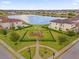 Beautiful aerial view overlooking a well-maintained community playground and sparkling lake at 10257 Henbury St, Orlando, FL 32832