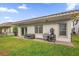 A patio with a covered grill and outdoor seating in a fenced backyard at 10257 Henbury St, Orlando, FL 32832
