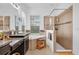 Bright bathroom featuring a double vanity, soaking tub, and a glass-enclosed shower for a spa-like experience at 10257 Henbury St, Orlando, FL 32832