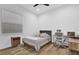 Bright bedroom with natural light from a window, offering a comfortable bed and a functional workspace at 10257 Henbury St, Orlando, FL 32832
