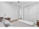 Neutral bedroom with closet and ensuite bath, light wood flooring and calming decor at 10257 Henbury St, Orlando, FL 32832