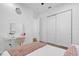 Bedroom featuring a vanity area, closet, and ensuite bath, with light wood flooring and calming decor at 10257 Henbury St, Orlando, FL 32832
