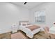 Sunlit bedroom with stylish wood floors, a comfortable bed, and a vanity area for a relaxing retreat at 10257 Henbury St, Orlando, FL 32832
