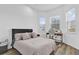 Bright bedroom with a large bed, natural light from multiple windows, and wood-look flooring for a modern feel at 10257 Henbury St, Orlando, FL 32832