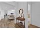 Inviting entryway featuring wood-look tile floors and charming decor, leading into a bright, open living space at 10257 Henbury St, Orlando, FL 32832