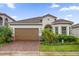 Charming single-story home featuring a tile roof, two-car garage, and well-manicured landscaping at 10257 Henbury St, Orlando, FL 32832