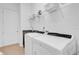 Functional laundry room with modern washer and dryer, sink, and storage shelving at 10257 Henbury St, Orlando, FL 32832