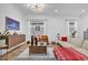 Comfortable living room with wood-look flooring, modern decor, and large windows that provide natural light at 10257 Henbury St, Orlando, FL 32832