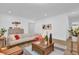 Bright and airy living room with a cozy sofa, stylish decor, wood-look flooring, and plenty of natural light at 10257 Henbury St, Orlando, FL 32832