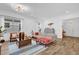 Cozy living room with ample natural light, modern furnishings, a wooden coffee table, and wood-look flooring at 10257 Henbury St, Orlando, FL 32832