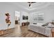 Bright main bedroom with wood floors, tray ceiling, ensuite bathroom and ceiling fan at 10257 Henbury St, Orlando, FL 32832