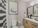 Bathroom featuring modern vanity, framed mirror, framed art, and shower with stylish black and white curtain at 1174 Villa Ln # 115, Apopka, FL 32712