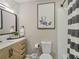 Bathroom featuring modern vanity, framed mirror, framed art, and shower with stylish black and white curtain at 1174 Villa Ln # 115, Apopka, FL 32712