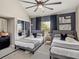 Comfortable bedroom features twin beds, ceiling fan, closet, neutral gray tones and plenty of natural light at 1174 Villa Ln # 115, Apopka, FL 32712