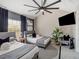 Comfortable bedroom featuring twin beds, large ceiling fan, wall mounted TV and plenty of natural light at 1174 Villa Ln # 115, Apopka, FL 32712