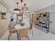 Bright dining area featuring tile floors, modern lighting, and access to kitchen at 1174 Villa Ln # 115, Apopka, FL 32712