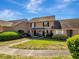 Exterior view of townhouses, showcasing manicured lawns and inviting front entrances at 1174 Villa Ln # 115, Apopka, FL 32712