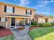 Lovely townhouse with well-kept lawn, complemented by dark shutters and a welcoming front entrance at 1174 Villa Ln # 115, Apopka, FL 32712
