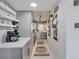Modern kitchen featuring gray cabinetry, floating shelves, and updated countertops at 1174 Villa Ln # 115, Apopka, FL 32712