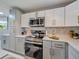 Contemporary kitchen showcasing stainless steel appliances and stylish cabinetry, ready for cooking at 1174 Villa Ln # 115, Apopka, FL 32712
