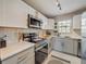 Bright, modern kitchen with stainless steel appliances, white cabinets, and ample counter space at 1174 Villa Ln # 115, Apopka, FL 32712